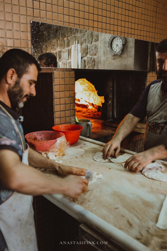 Bakers working on the bread baking process in a Mardin bakery.