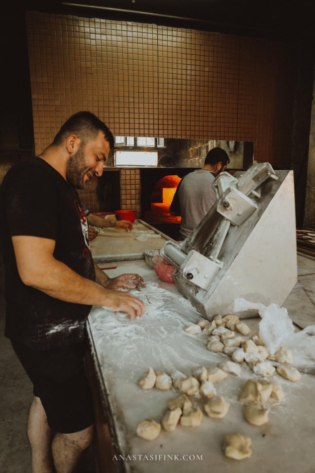 Baker preparing dough for bread in a traditional bakery in Mardin.