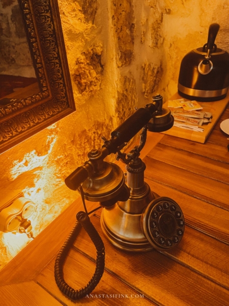 Antique rotary phone on a wooden nightstand at Sanliurfa Babel Hotel.