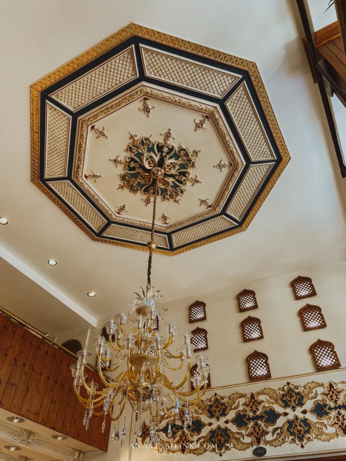 Decorative ceiling in a restaurant with a chandelier