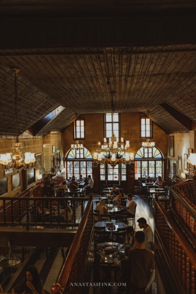 The interior of Tahmis Kahvesi Coffeehouse, showing seating arrangements and traditional decor.