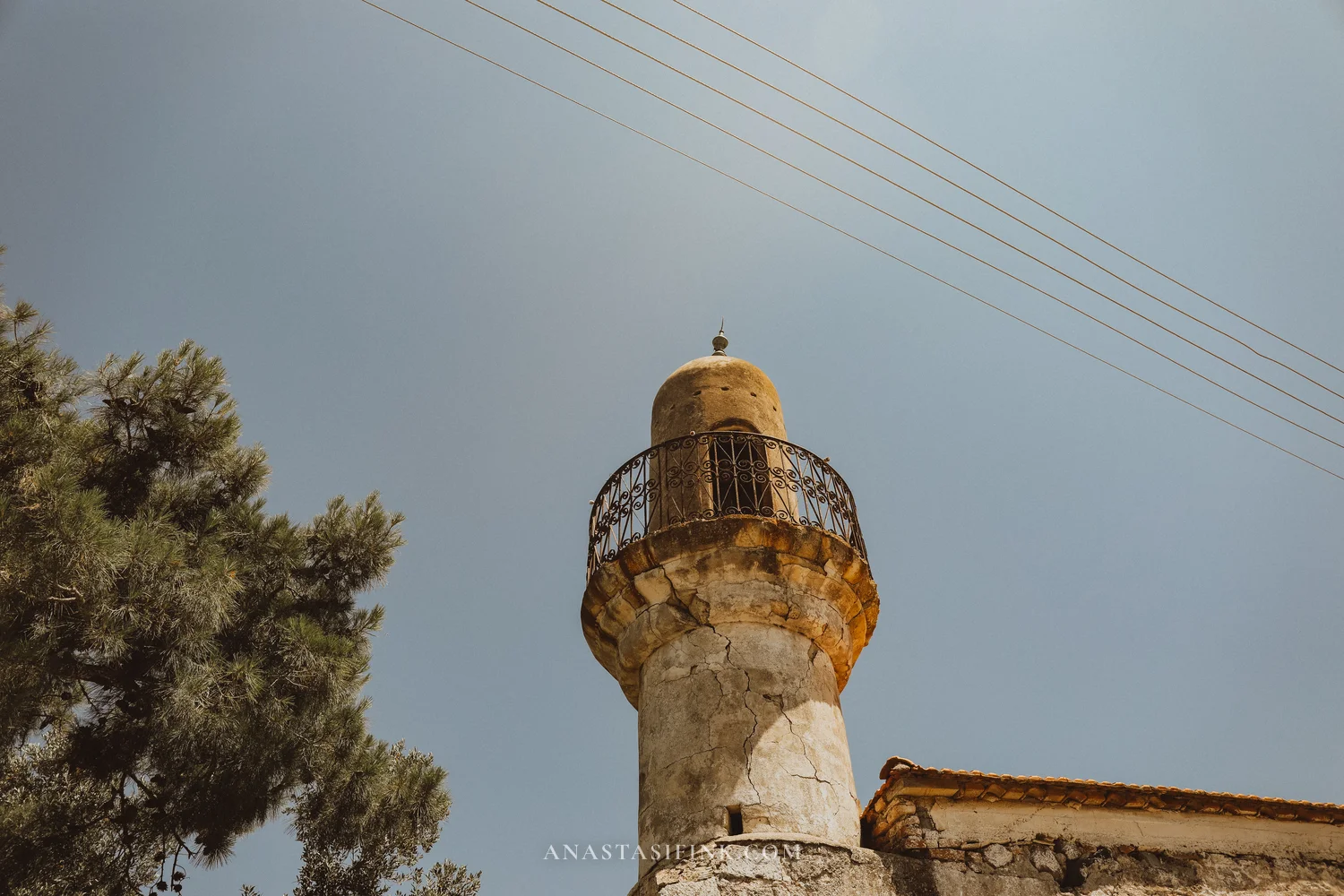 Old mosque minaret against the sky