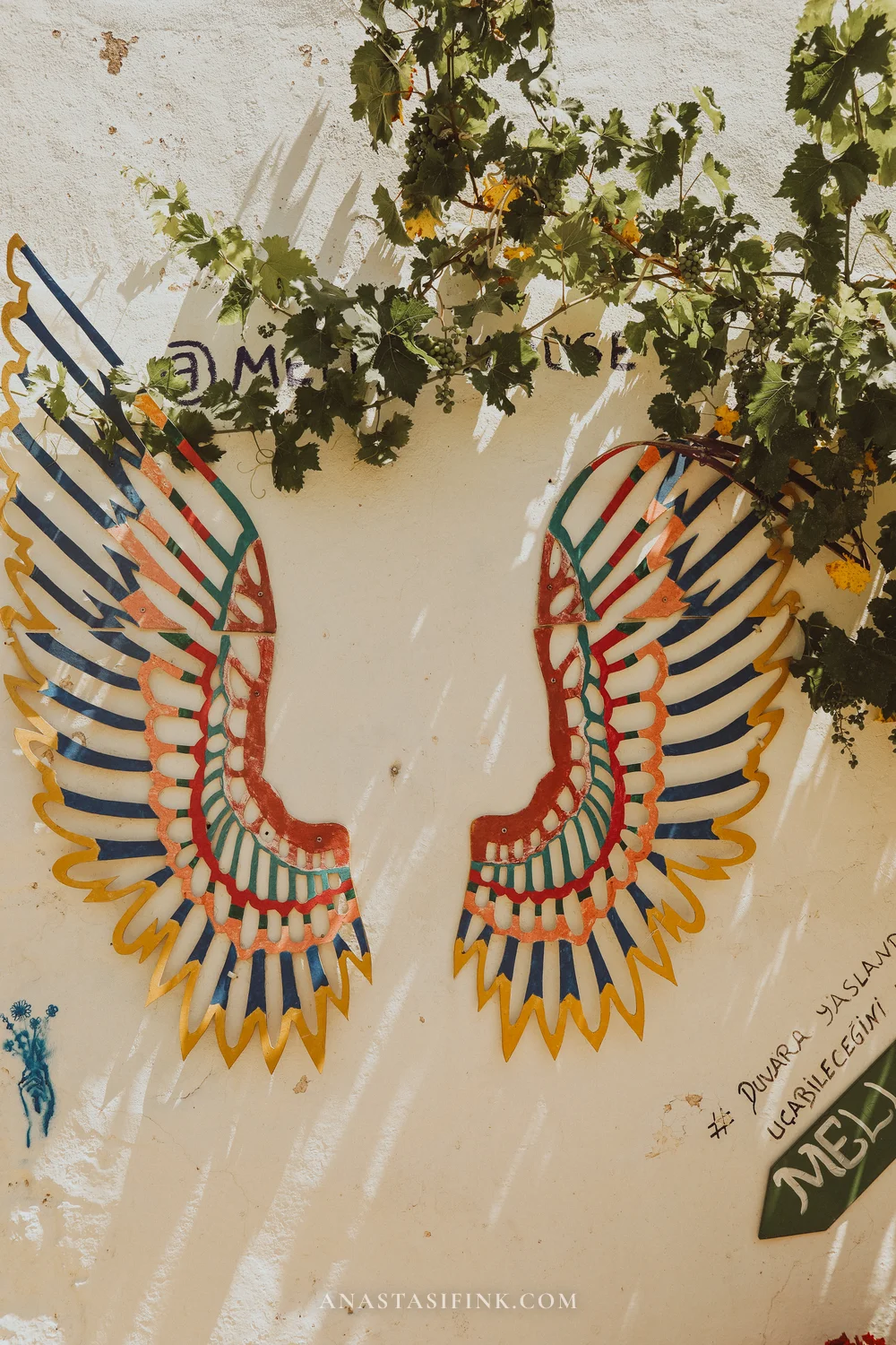 Wings on a white wall — art installation for photos