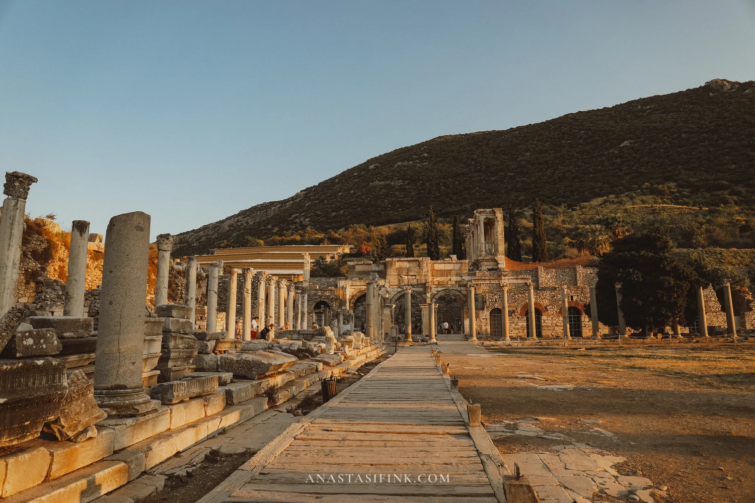 Colonnade of the Stoa with a wooden walkway and gate in the distance