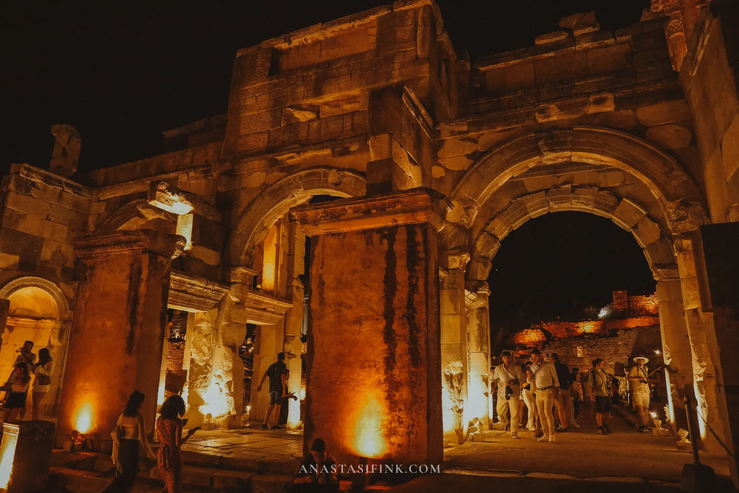 Gate of Mazaeus at night, people near illuminated columns