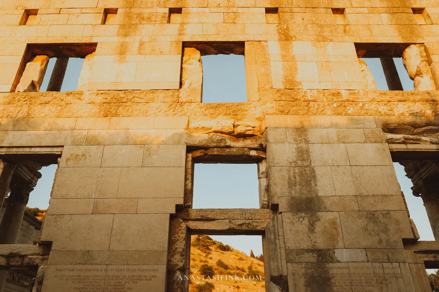 Back wall of the Library of Celsus with window openings in warm light