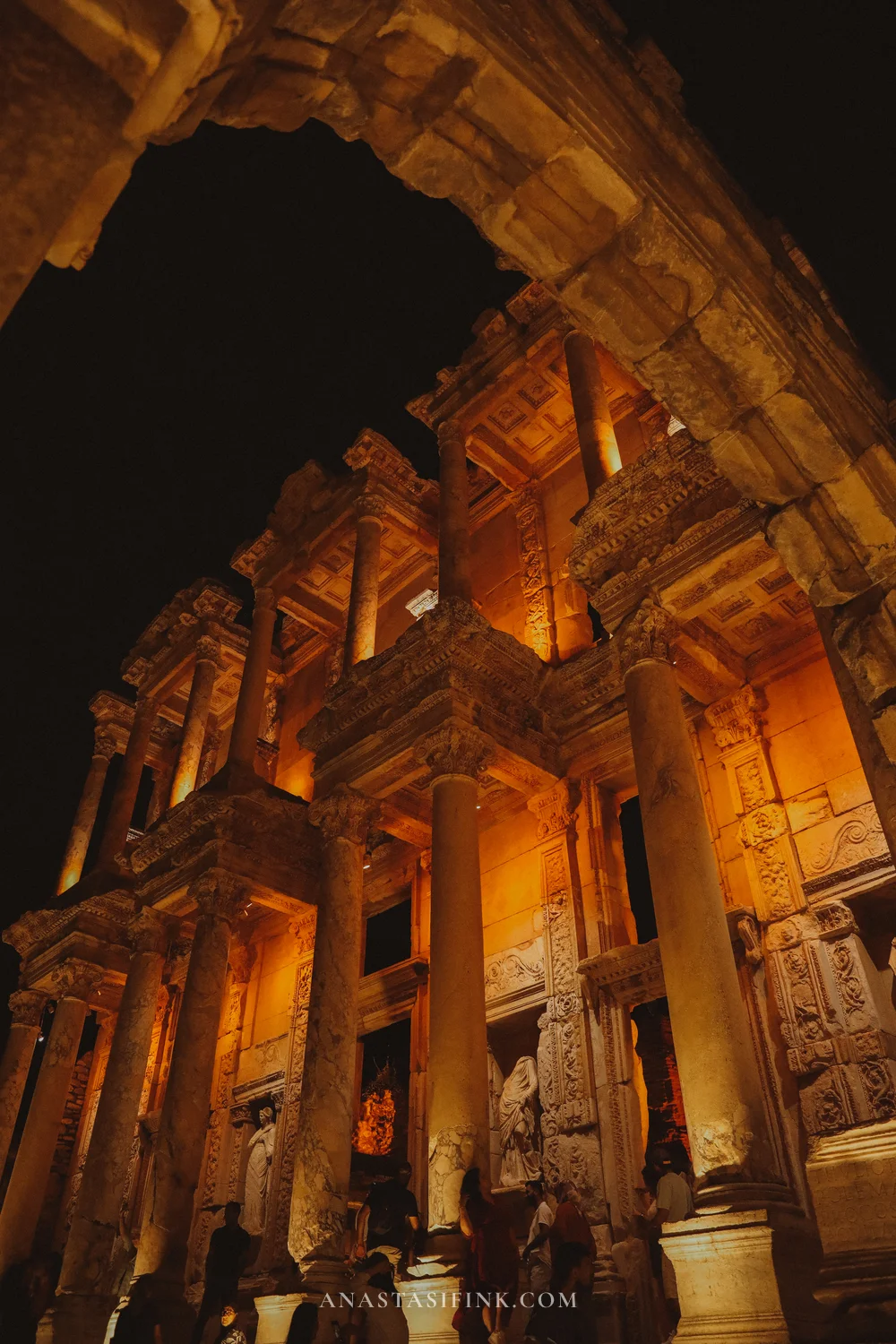 Library through an arch, night illumination, black and gold contrast