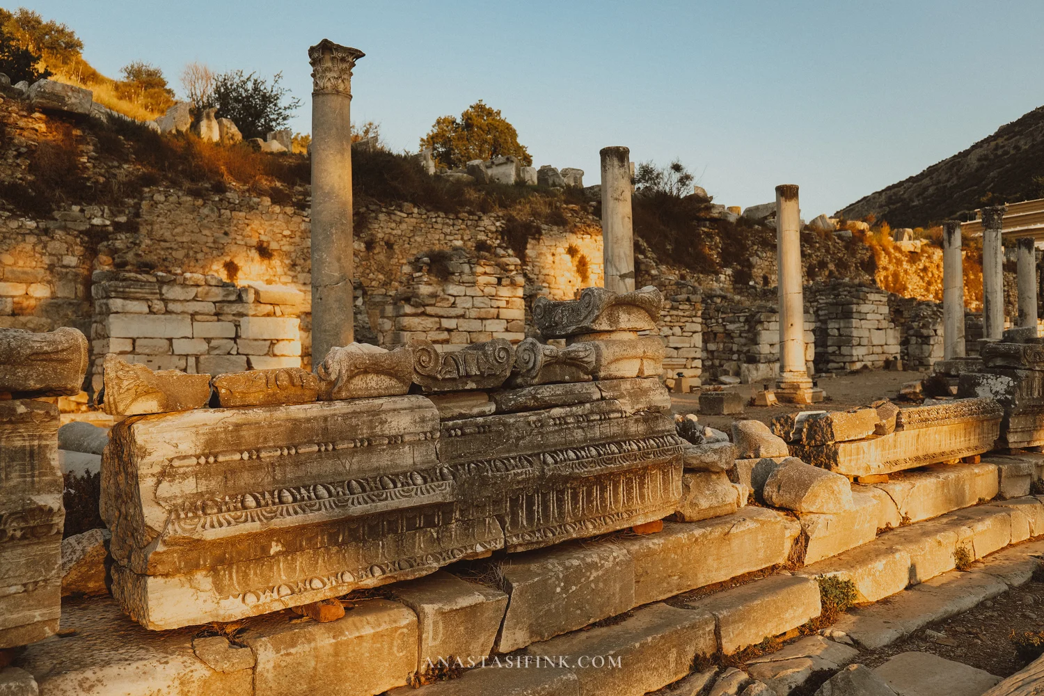 Marble entablature with carved details in evening light