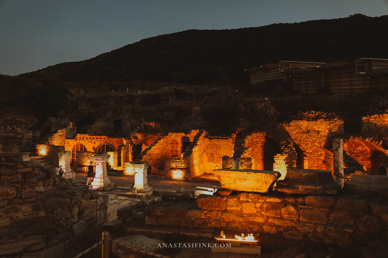 Ruins illuminated at night, sarcophagi and columns