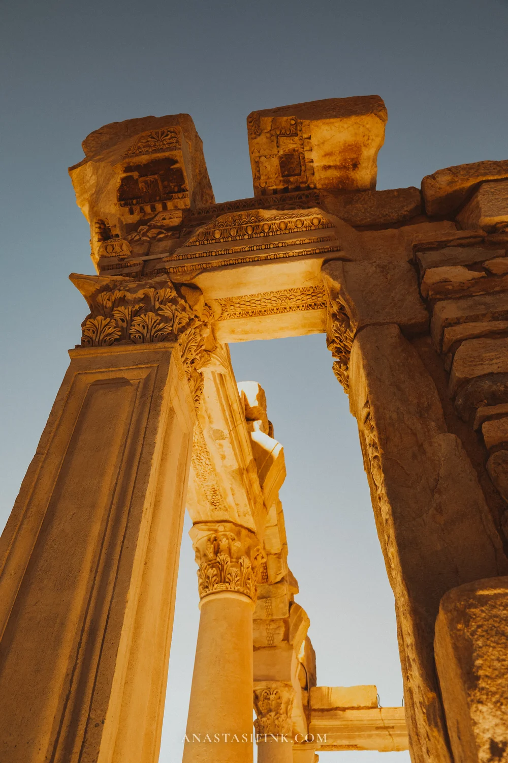 Temple of Hadrian, looking up at the arch ornament and capitals