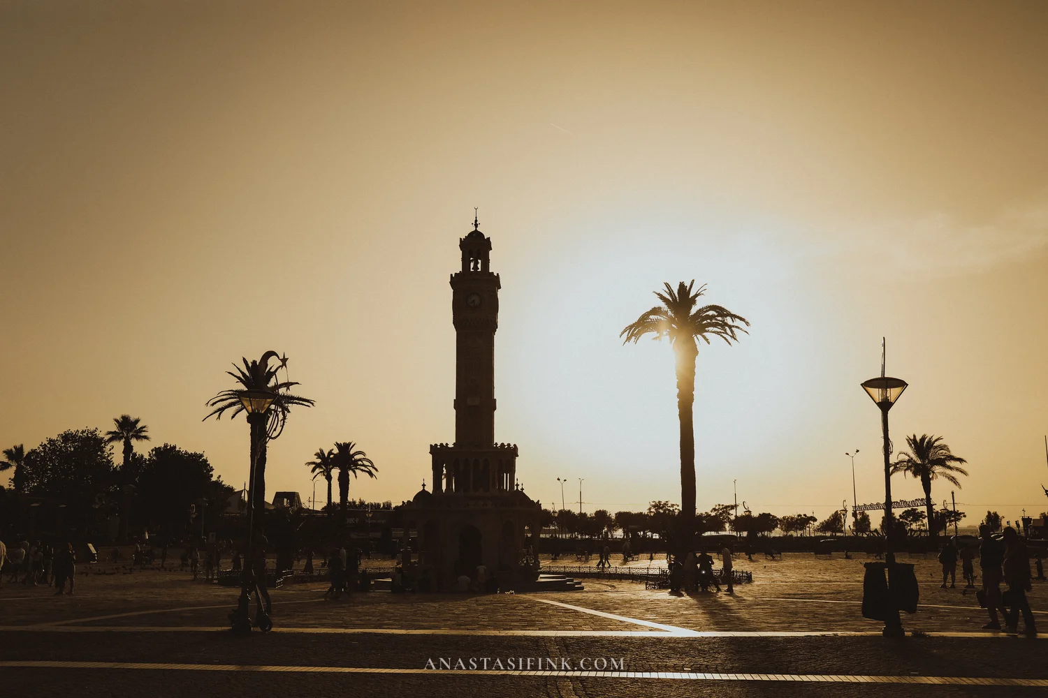 Konak Square in the evening — tower silhouette against the sunset