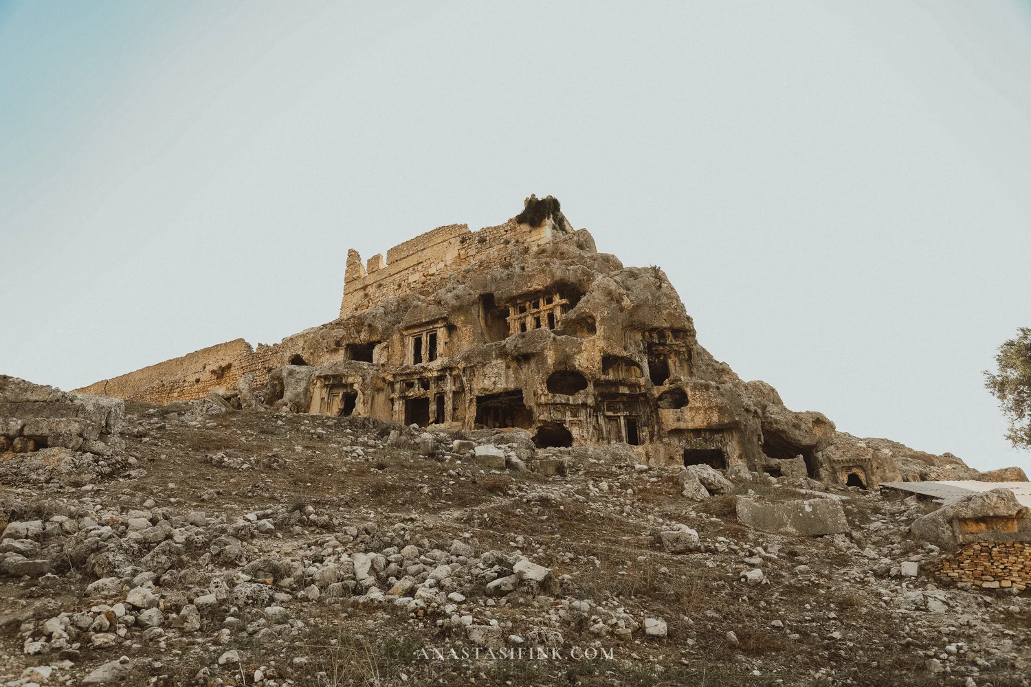 Rock tombs and acropolis — wide shot