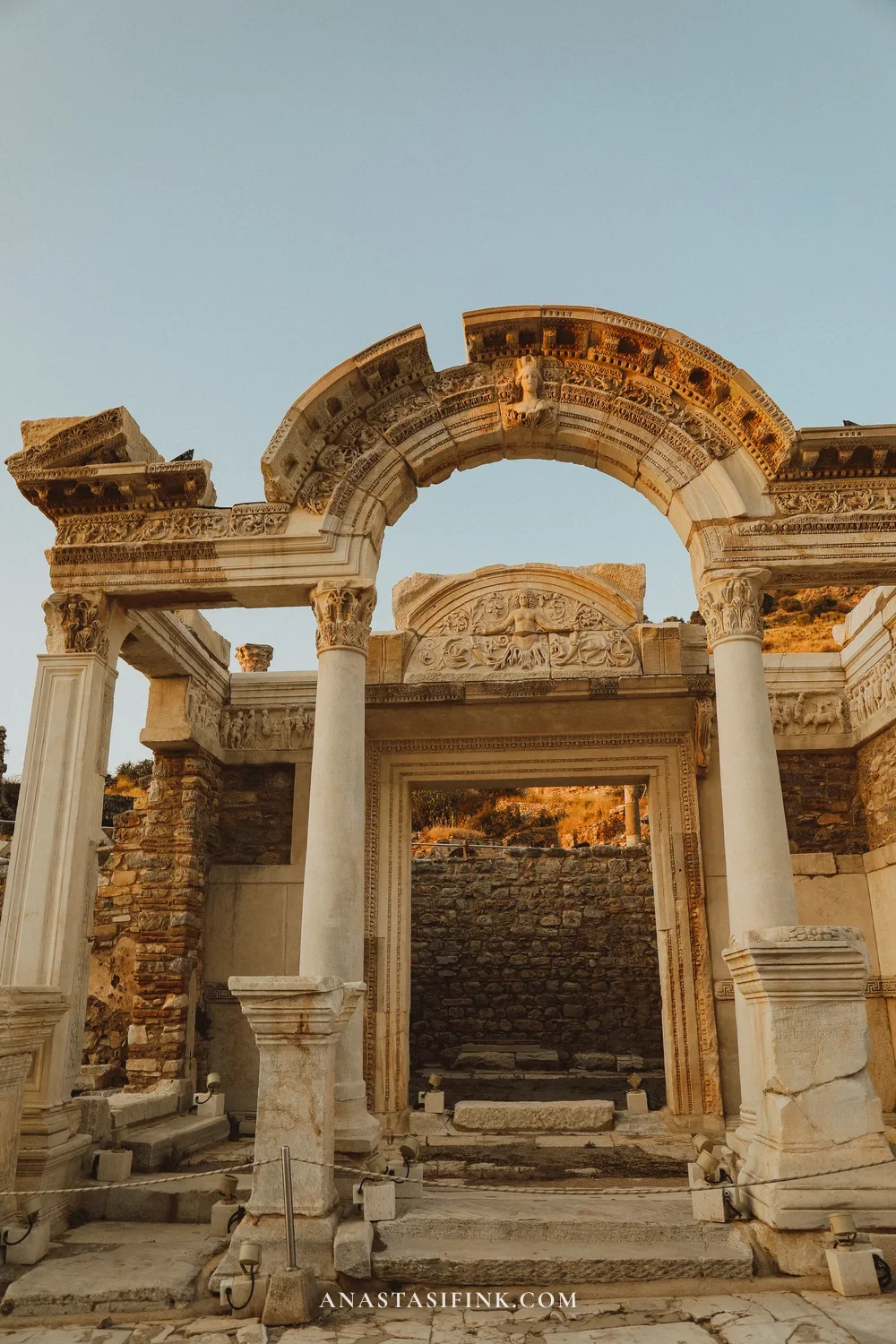 Temple of Hadrian in Ephesus at sunset — marble arch with Medusa and Corinthian columns