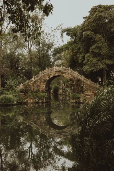 Stone arched "moon bridge" in Huanglongxi reflected in the water as a perfect circle