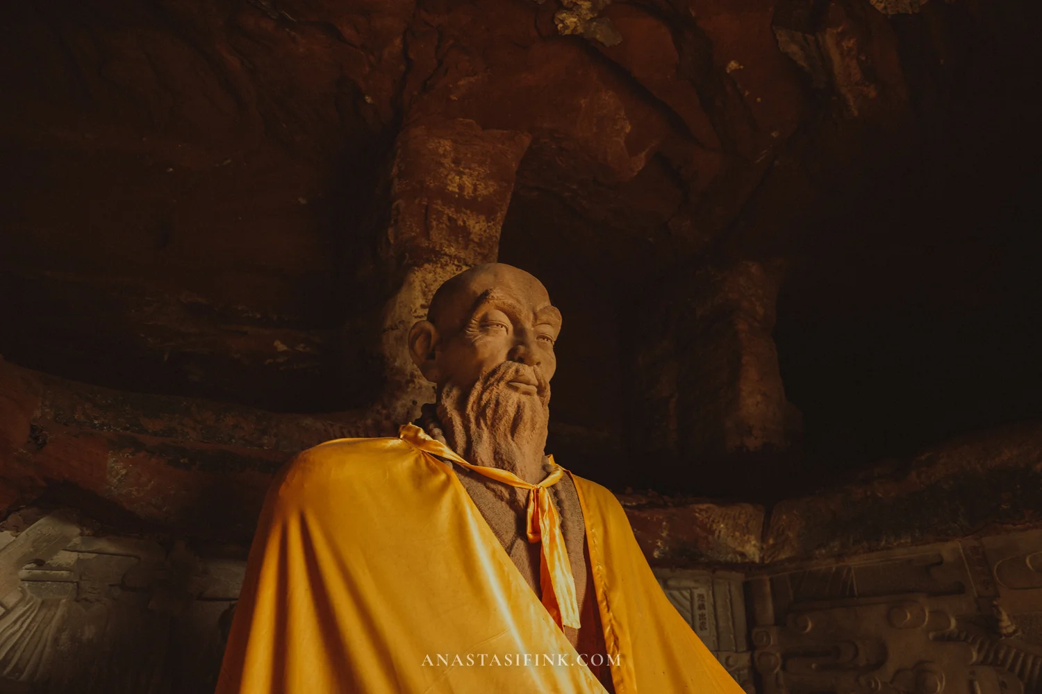 Statue of a robed sage in the cave