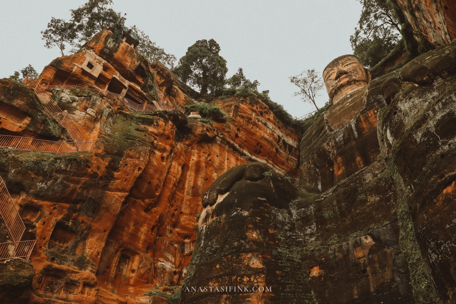 Looking up at the body of the Leshan Giant Buddha and the cliff niches