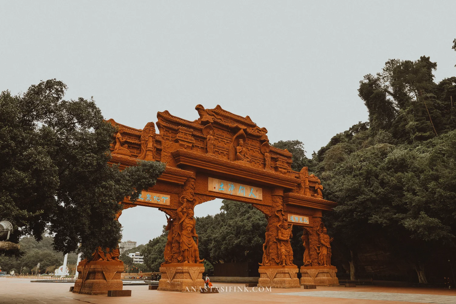 Carved stone paifang gate at the entrance to the Giant Buddha park