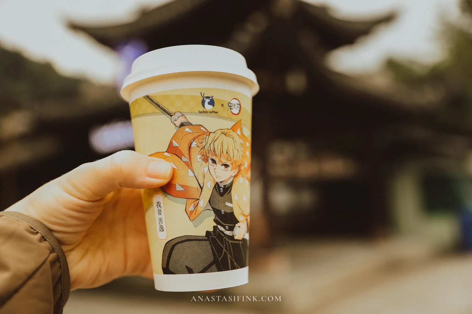 Luckin Coffee cup in front of a temple at the Leshan Giant Buddha