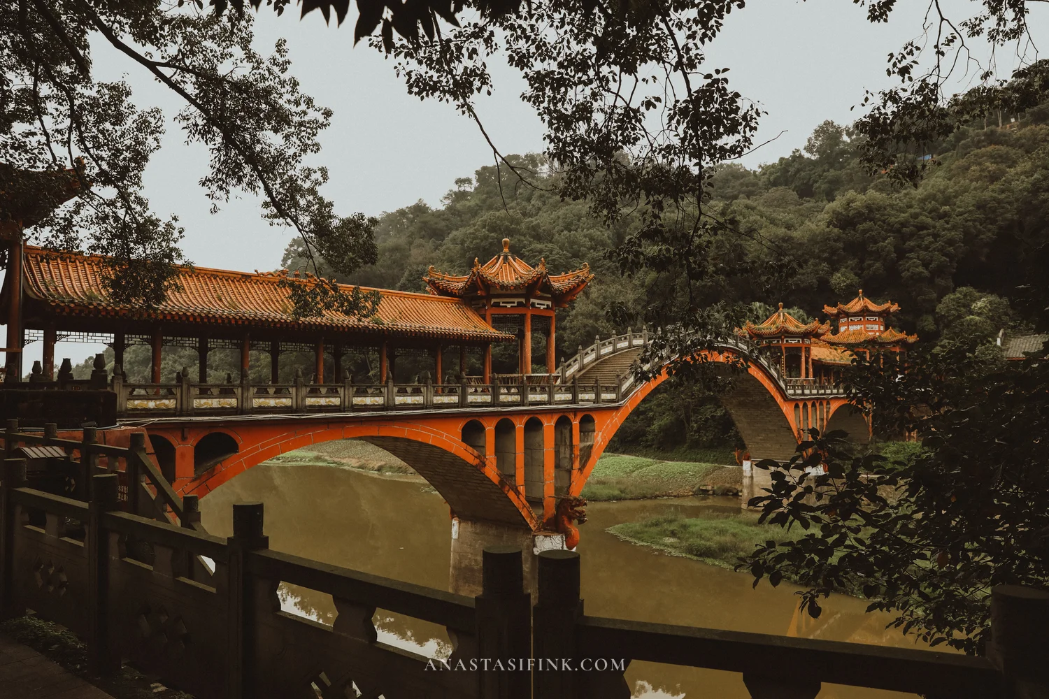 Arched Haoshang Bridge with pavilions, seen from the bank