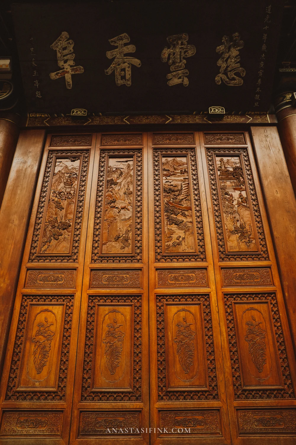Carved wooden temple doors with ornamentation