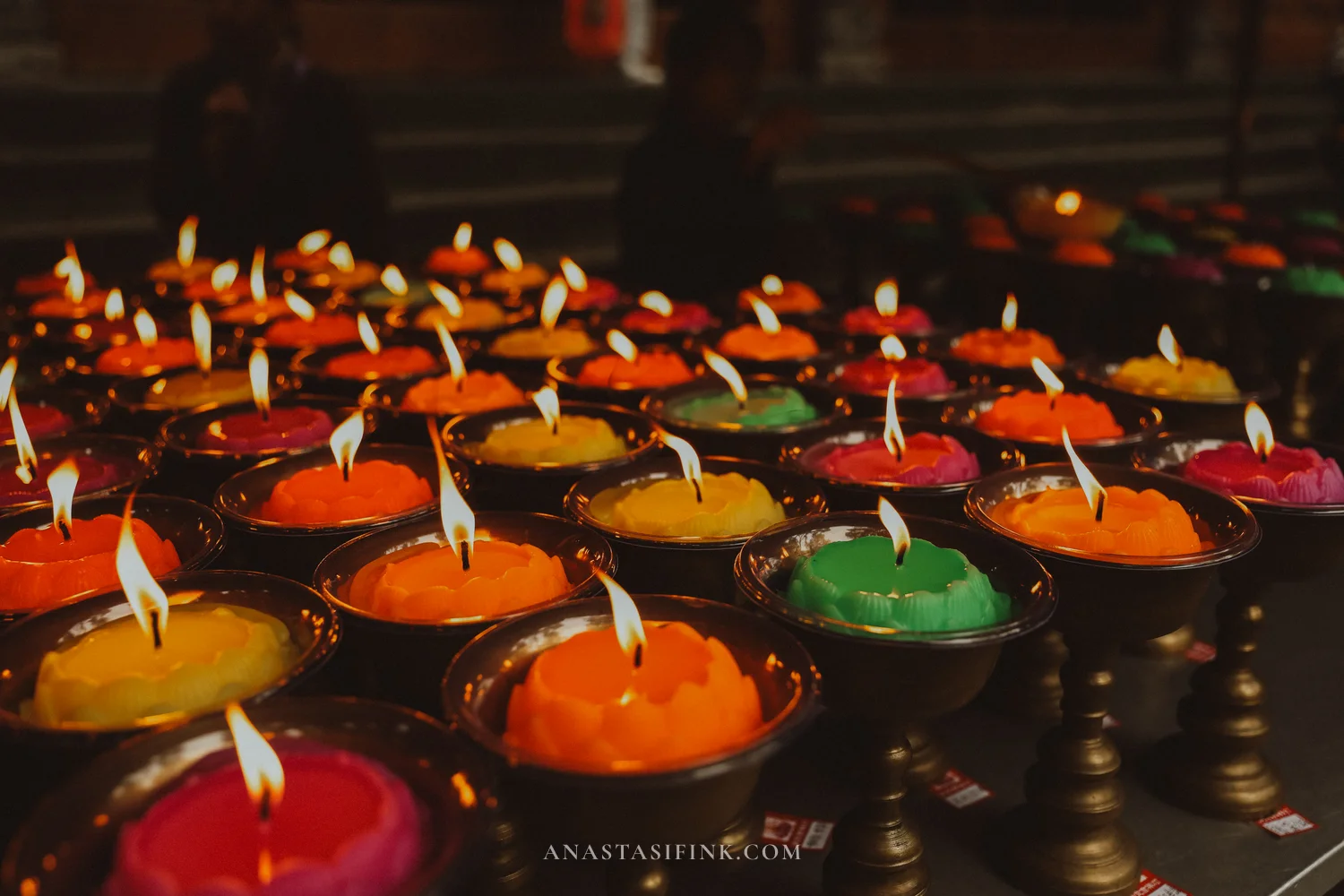 Colourful lotus-shaped candles in the temple