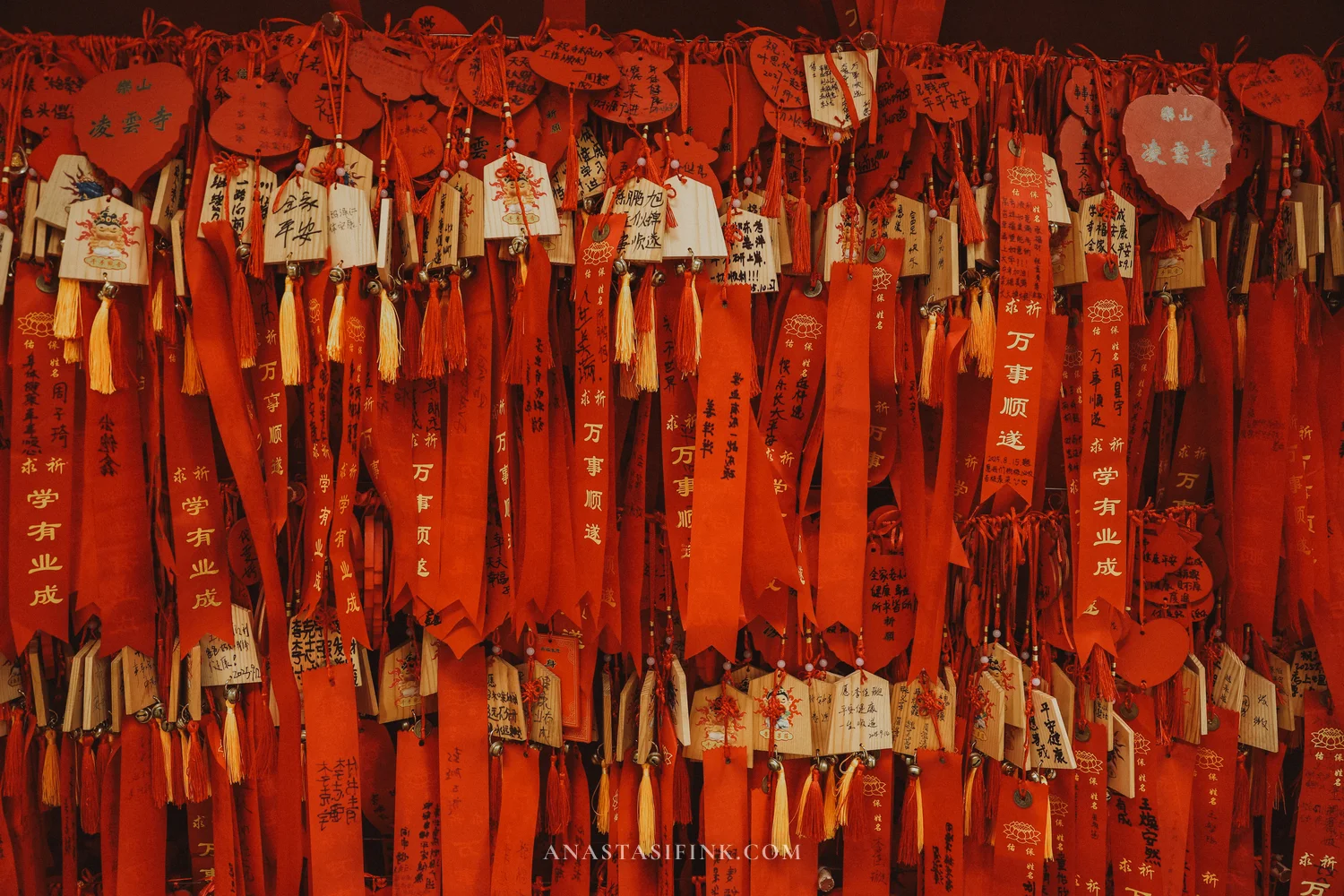 Wall of red ribbons and wish tablets at Lingyun Temple