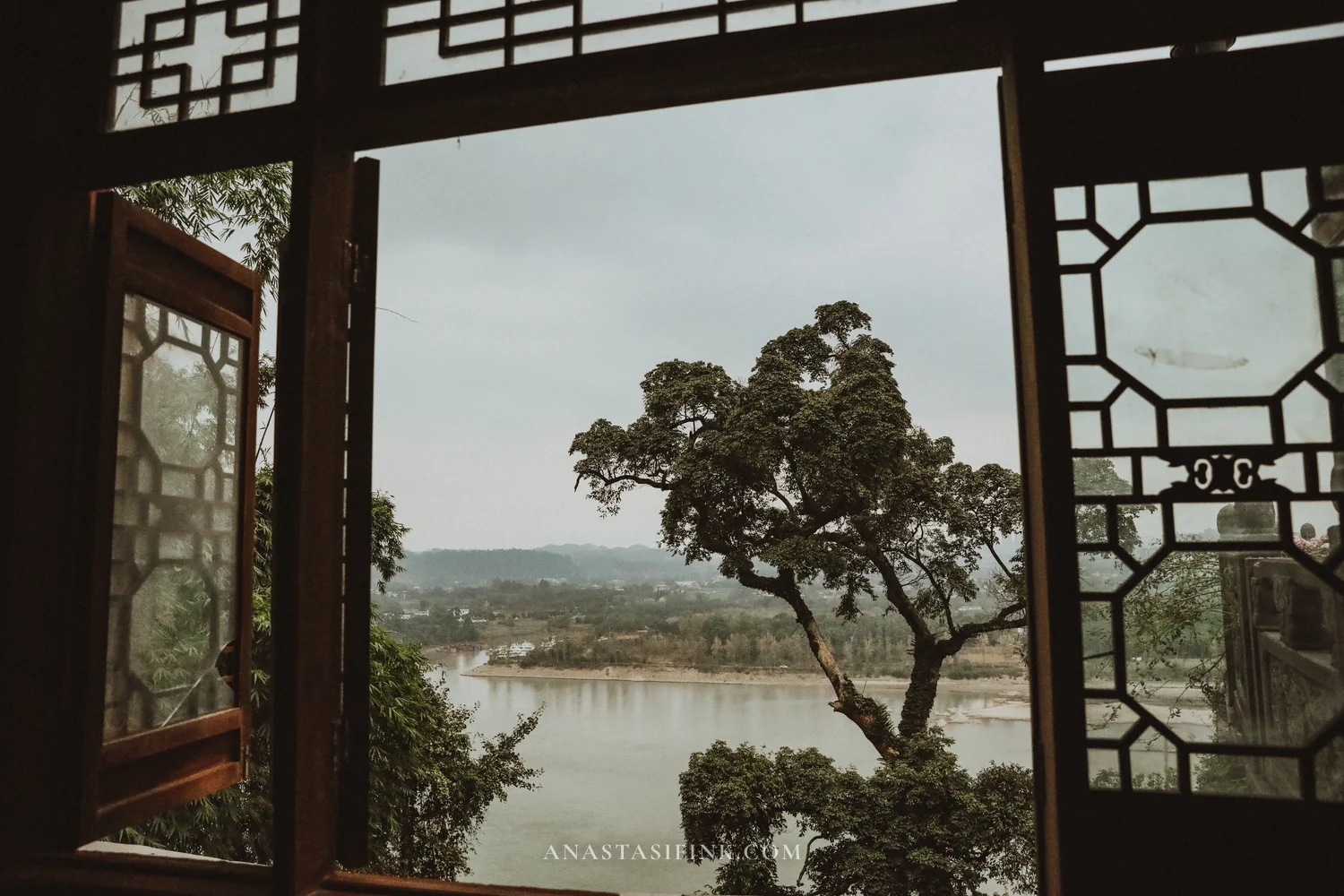 River view through a carved temple window at Wuyou Temple