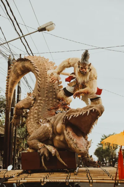 Ogoh-Ogoh battle scene — white monkey attacking a giant crocodile at a Bali street parade