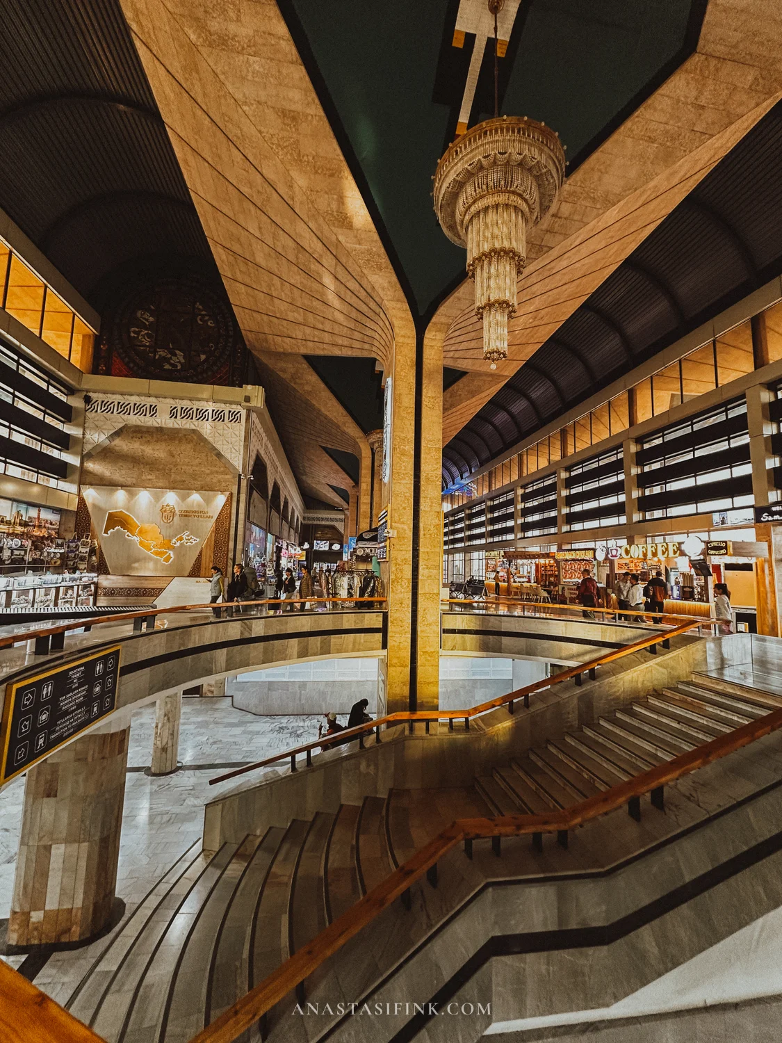 Interior of Samarkand railway station — chandelier, marble staircase and a map of Uzbekistan