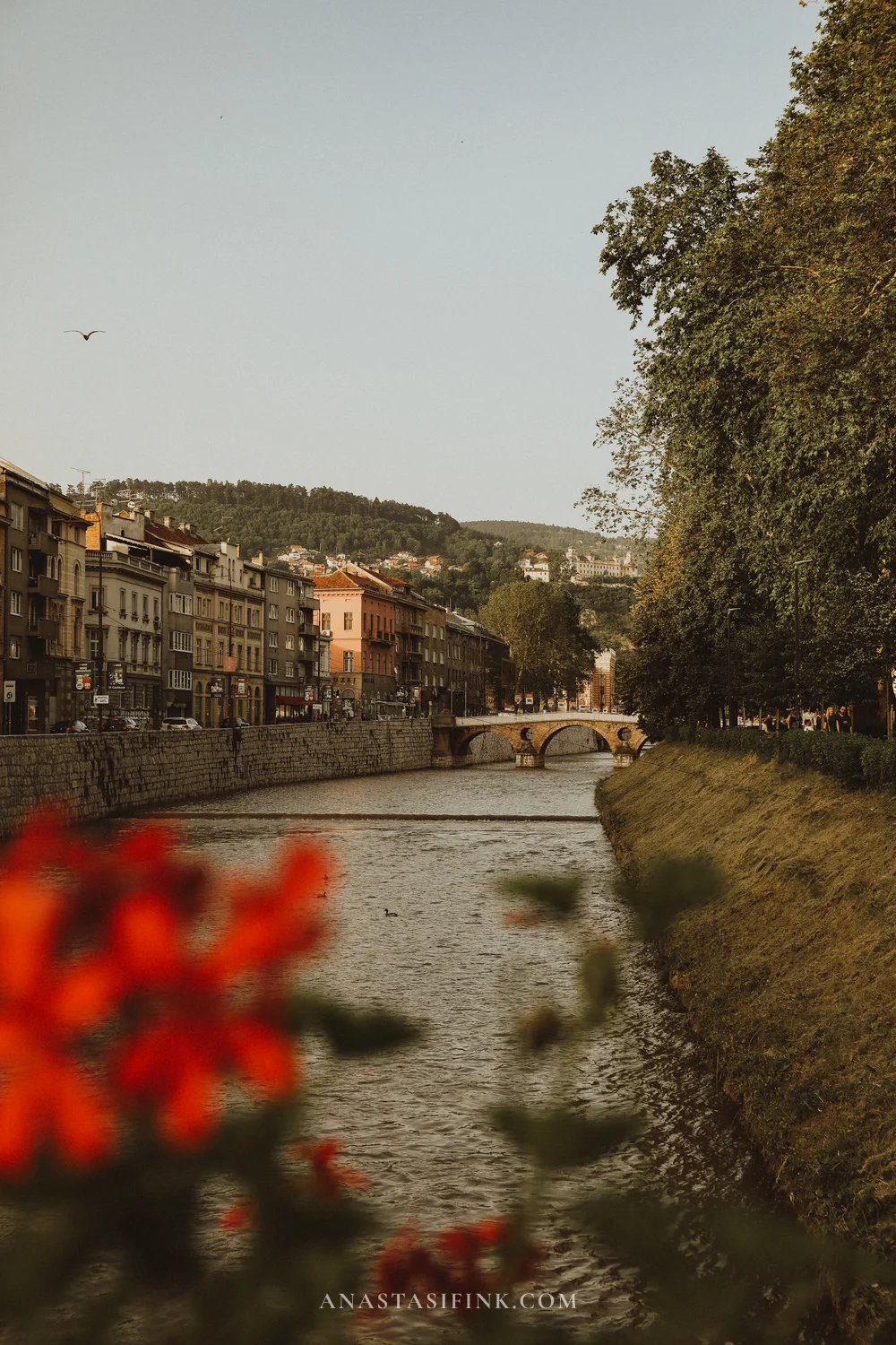 View along the Miljacka river with bridges and hills above Sarajevo