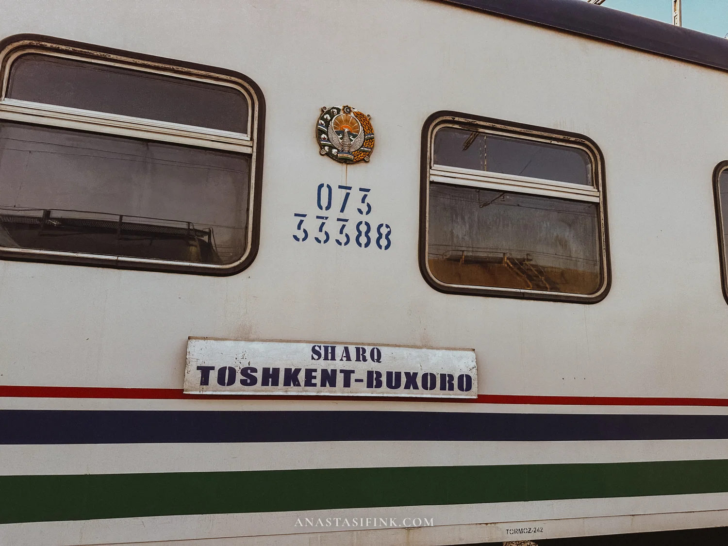 Sharq train carriage with a Tashkent–Bukhara route sign