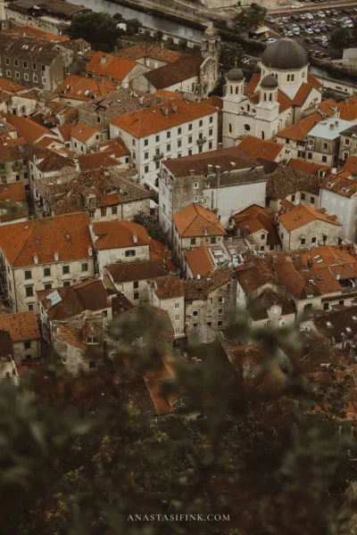 Kotor rooftops with the domes of St. Nicholas church seen from the city walls trail