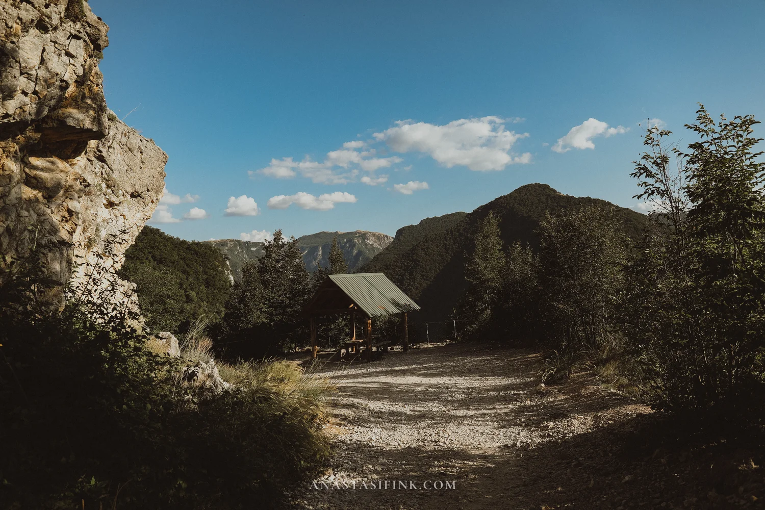 Gravel parking area with a wooden shelter at Piva Canyon viewpoint, Montenegro