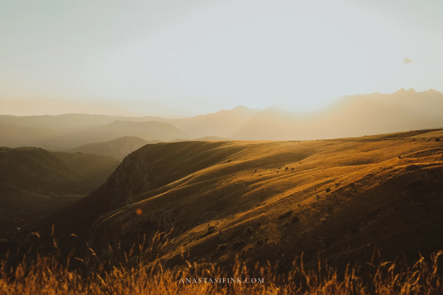 Golden evening light on the grassy slopes above the canyon at Sedlo Pass, Durmitor