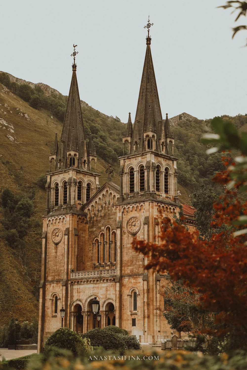 Basilica of Covadonga with twin spires and an autumn tree, Asturias, Spain