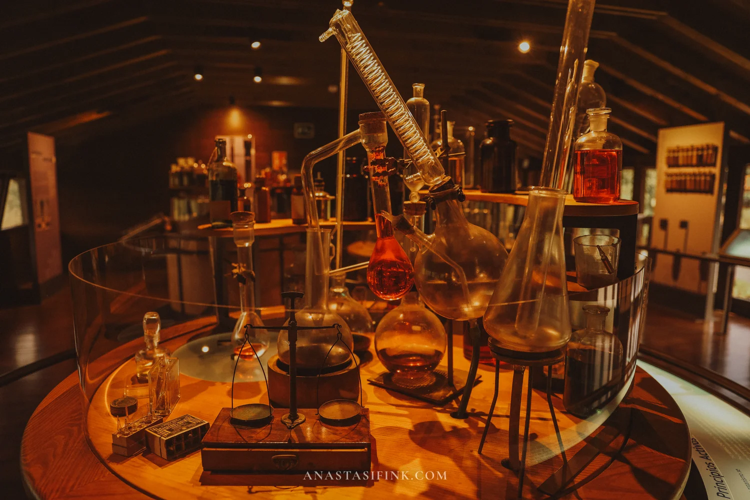 Old laboratory glassware display in the exhibition hall of the Gijón Botanical Garden