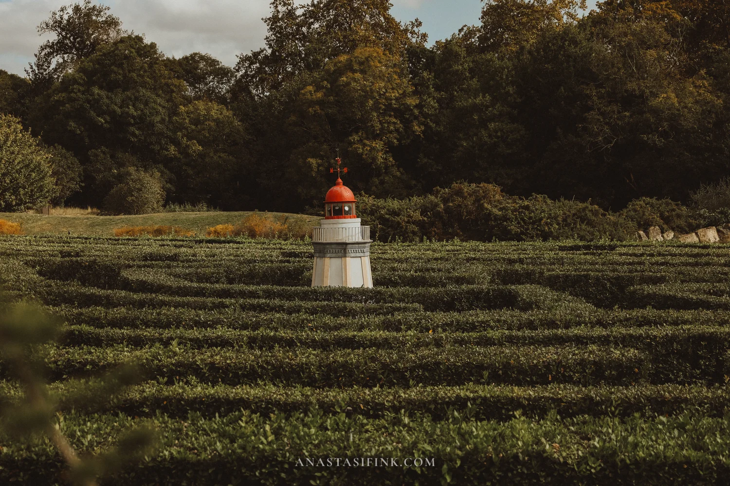 White lighthouse replica in the centre of the laurel maze at the Atlantic Botanical Garden of Gijón