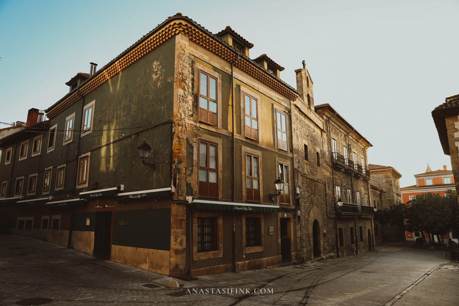 Old corner house with a green facade in the Cimavilla quarter of Gijón