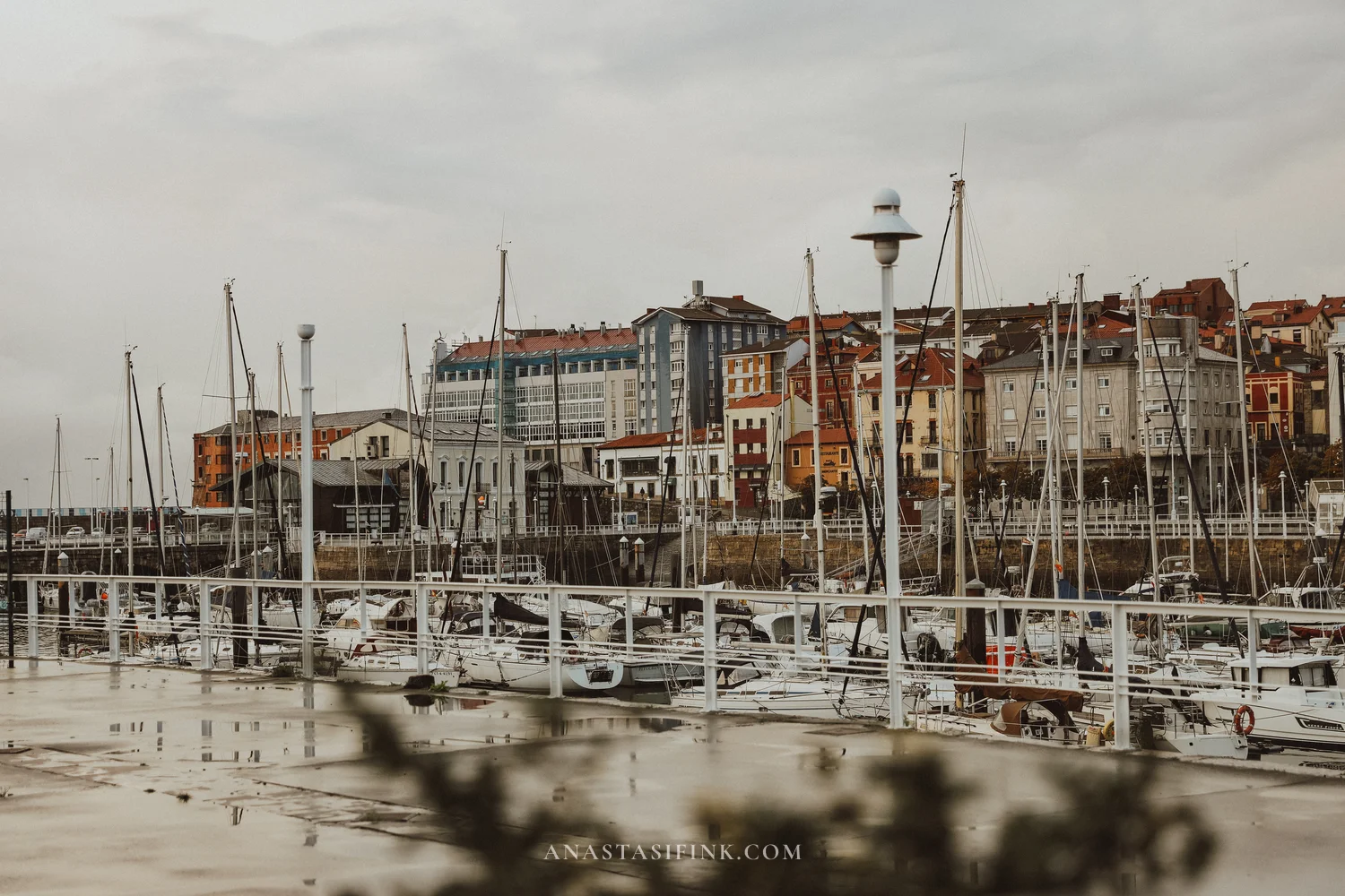 Colourful facades of Cimavilla above the marina of Gijón on a grey morning