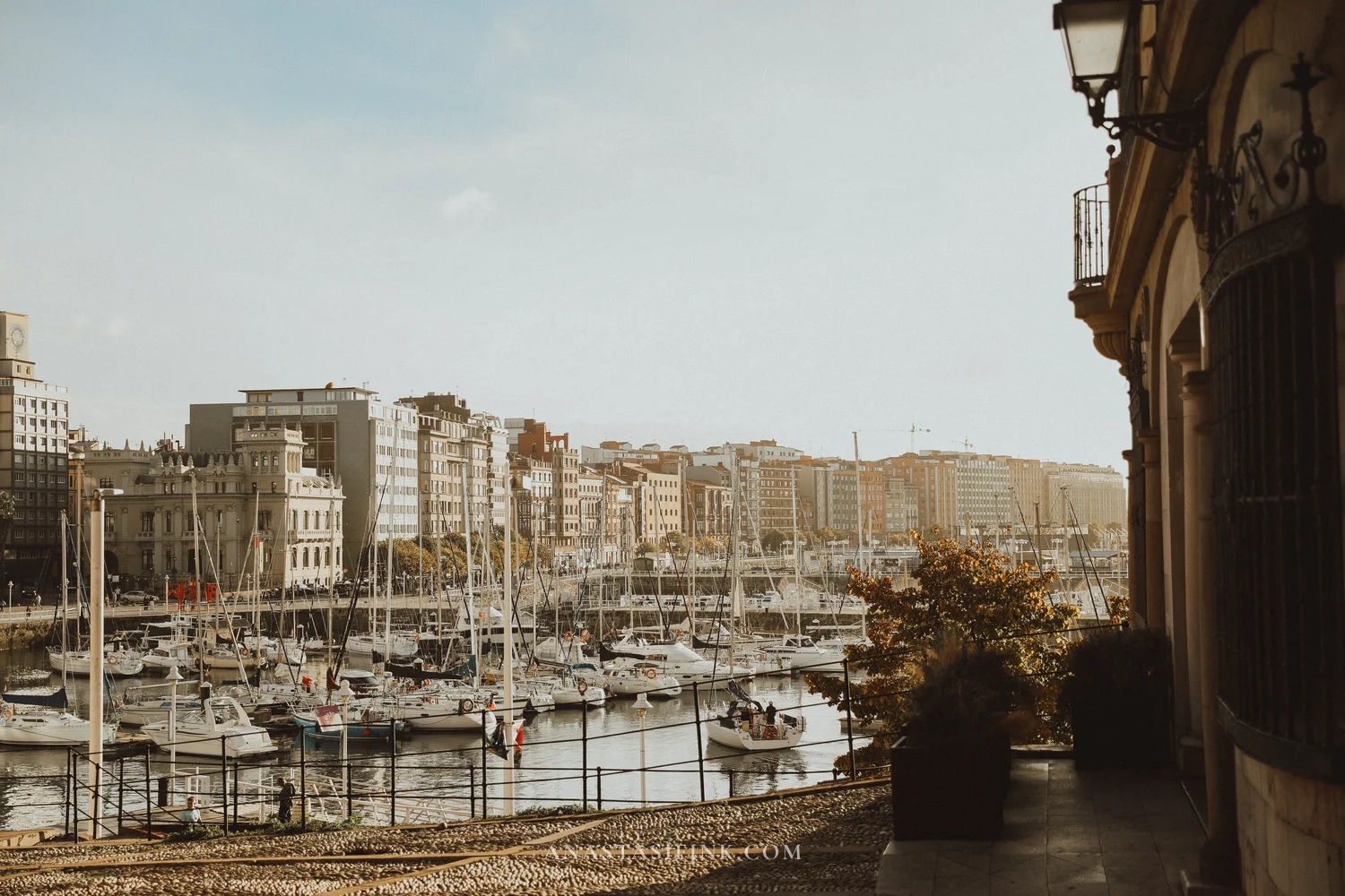 Marina of Gijón with yachts and city buildings seen from Cimavilla