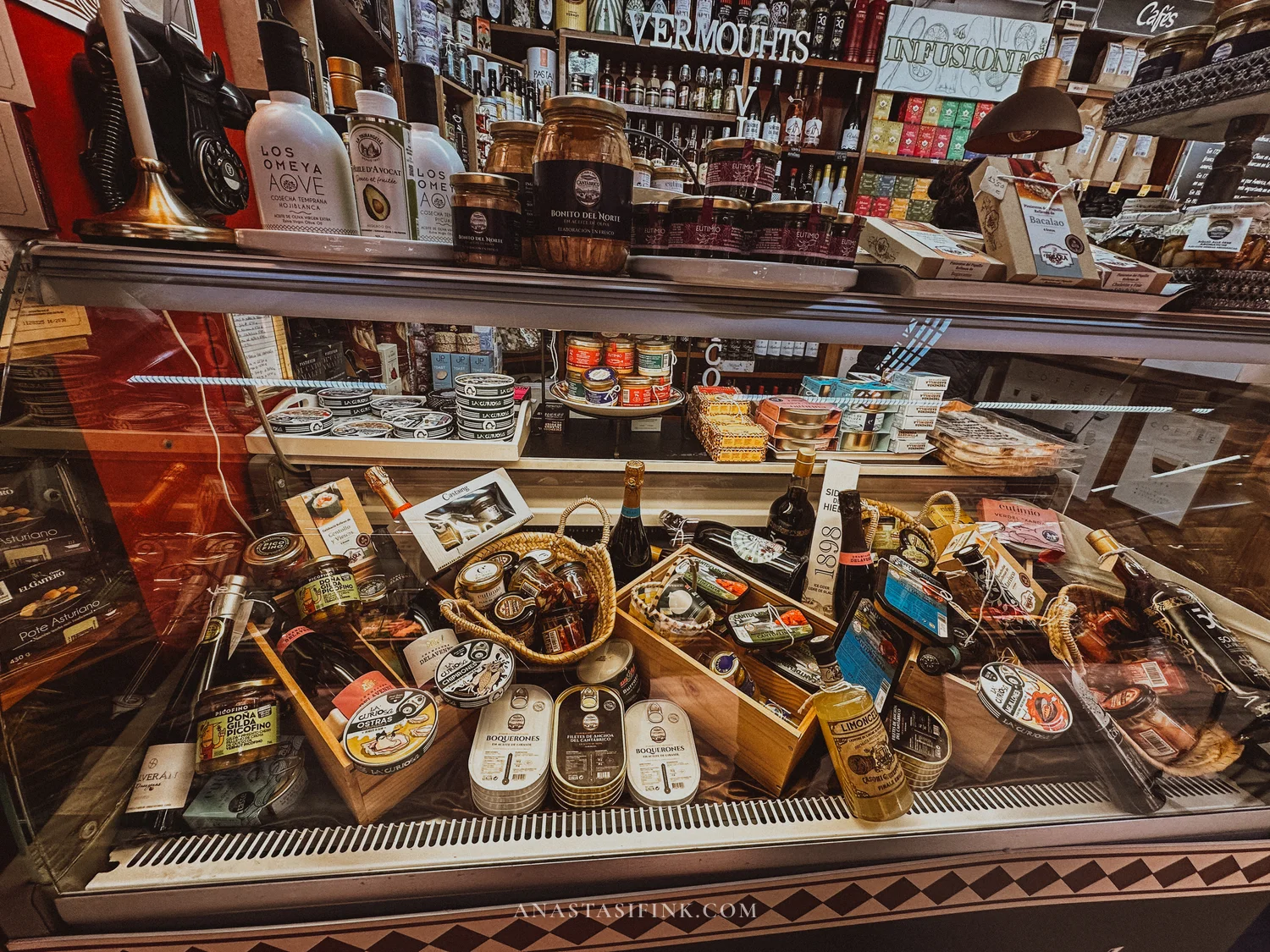 Delicatessen counter at Mercado del Sur in Gijón with tinned seafood, olive oil and vermouth
