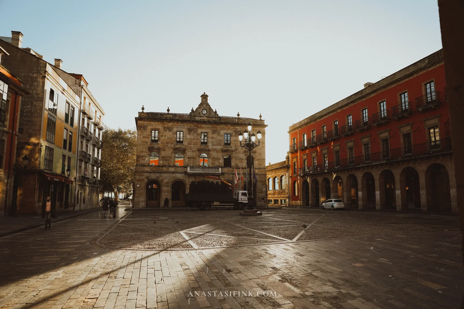 Plaza Mayor of Gijón with the town hall and arcaded buildings in early morning light